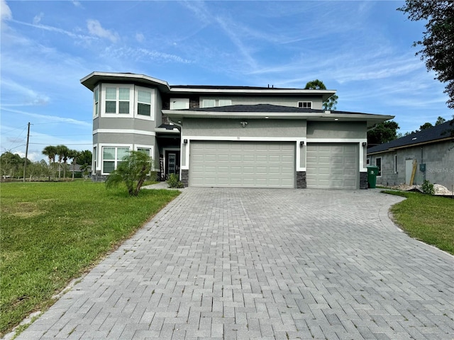 22223 Seyburn Ter, Port Charlotte, FL 33954 - prairie-style home featuring a front yard, an attached garage, stone siding, stucco siding, and decorative driveway