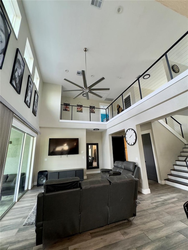 22223 Seyburn Ter, Port Charlotte, FL 33954 - living room featuring stairs, visible vents, a ceiling fan, and wood finished floors