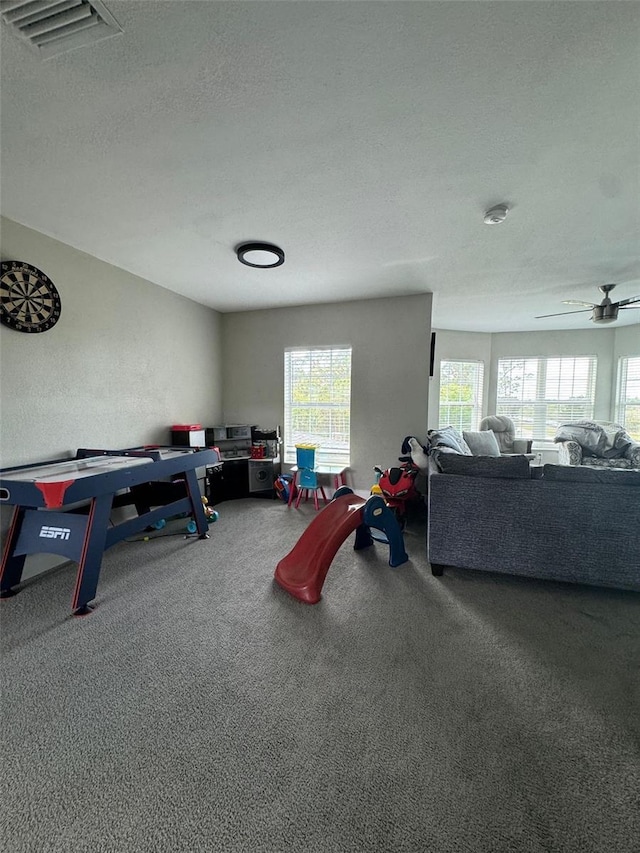 22223 Seyburn Ter, Port Charlotte, FL 33954 - playroom with visible vents, a ceiling fan, carpet floors, and a textured ceiling