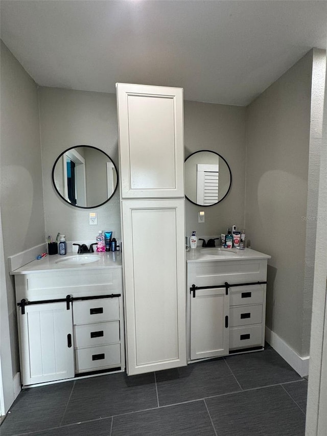 22223 Seyburn Ter, Port Charlotte, FL 33954 - bathroom with a sink, two vanities, and baseboards