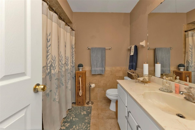 4420 Larkspur Ct, Port Charlotte, FL 33948 - bathroom featuring tile walls, a wainscoted wall, toilet, tile patterned floors, and vanity