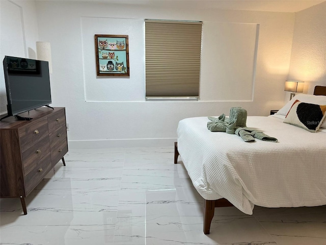 bedroom with baseboards and marble finish floor