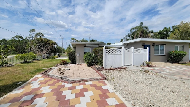 view of patio featuring fence and a gate