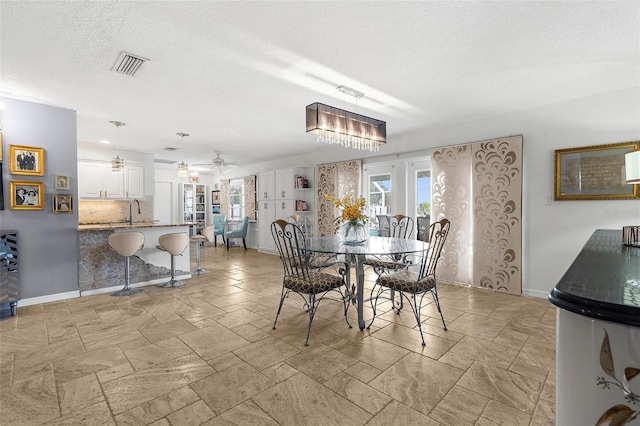 4168 Harbor Blvd, Port Charlotte, FL 33952 - dining room featuring baseboards, a ceiling fan, a textured ceiling, and visible vents