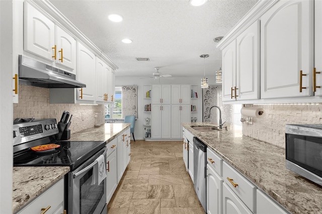 4168 Harbor Blvd, Port Charlotte, FL 33952 - kitchen with a sink, ceiling fan, appliances with stainless steel finishes, white cabinets, and under cabinet range hood