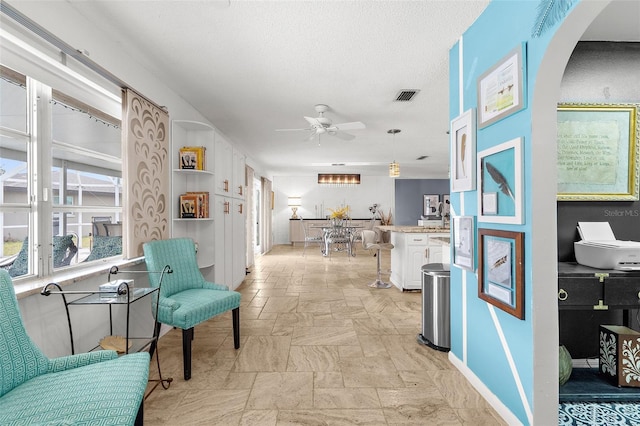 4168 Harbor Blvd, Port Charlotte, FL 33952 - hall with arched walkways, stone tile floors, visible vents, and baseboards