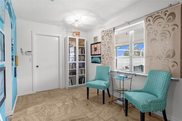 4168 Harbor Blvd, Port Charlotte, FL 33952 - living area with baseboards and a textured ceiling