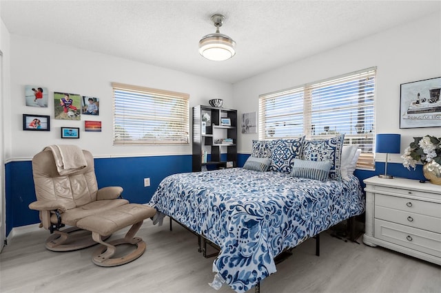 4168 Harbor Blvd, Port Charlotte, FL 33952 - bedroom with wood finished floors, a textured ceiling, baseboards, and multiple windows