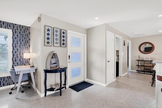280 Belvedere Ct, Punta Gorda, FL 33950 - foyer with wallpapered walls, baseboards, speckled floor, and a healthy amount of sunlight