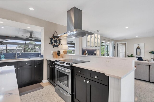 280 Belvedere Ct, Punta Gorda, FL 33950 - kitchen with light speckled floor, open floor plan, a peninsula, island exhaust hood, and electric range