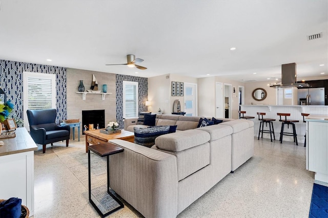 280 Belvedere Ct, Punta Gorda, FL 33950 - living room featuring a large fireplace, a ceiling fan, visible vents, and light speckled floor