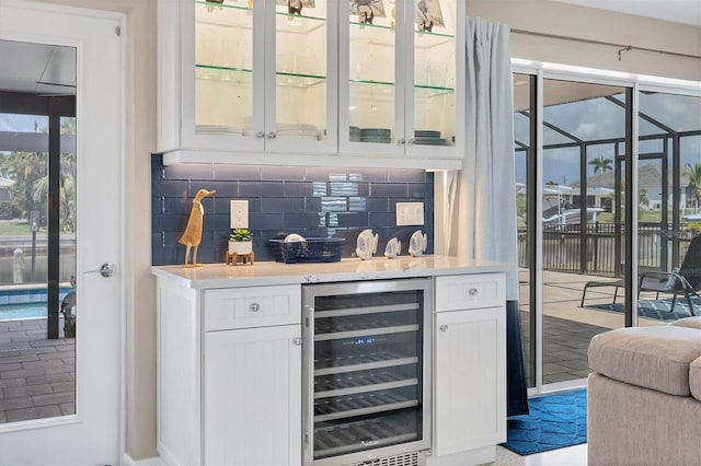 280 Belvedere Ct, Punta Gorda, FL 33950 - bar with wine cooler, decorative backsplash, and bar
