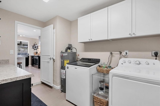 280 Belvedere Ct, Punta Gorda, FL 33950 - laundry room featuring cabinet space, electric water heater, washing machine and clothes dryer, and baseboards