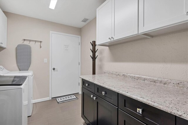 280 Belvedere Ct, Punta Gorda, FL 33950 - clothes washing area featuring cabinet space, visible vents, baseboards, and separate washer and dryer