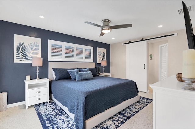 280 Belvedere Ct, Punta Gorda, FL 33950 - bedroom with baseboards, light speckled floor, a barn door, and recessed lighting