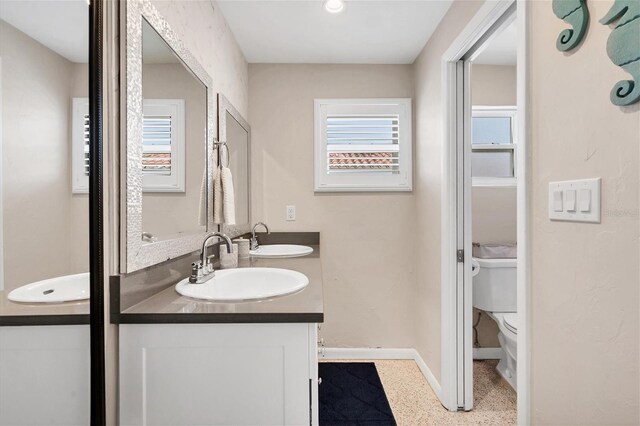 280 Belvedere Ct, Punta Gorda, FL 33950 - bathroom with double vanity, baseboards, a sink, and toilet