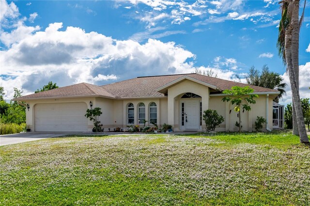 single story home with a front yard, driveway, and stucco siding