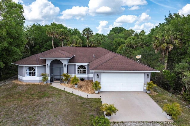 2661 30th Ave SE, Naples, FL 34117 - view of front of home featuring stucco siding, a front yard, an attached garage, a shingled roof, and driveway