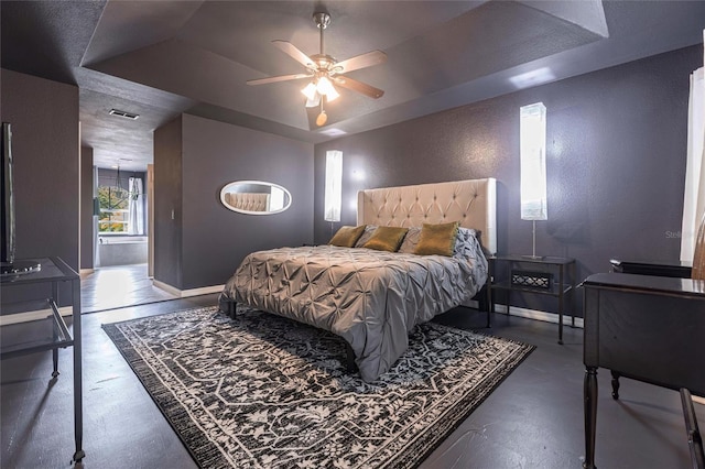 2661 30th Ave SE, Naples, FL 34117 - bedroom featuring baseboards, a textured wall, visible vents, a tray ceiling, and finished concrete floors