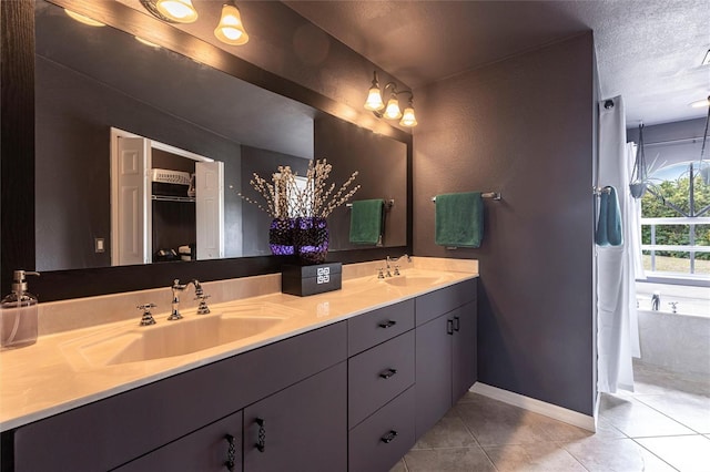 2661 30th Ave SE, Naples, FL 34117 - full bath with a textured ceiling, double vanity, a sink, and tile patterned flooring