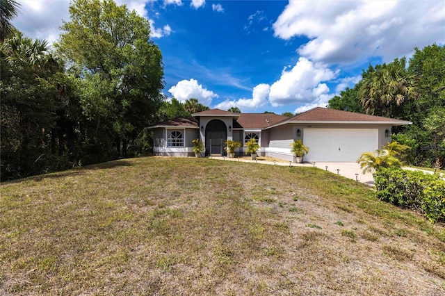 2661 30th Ave SE, Naples, FL 34117 - ranch-style home featuring a front yard, an attached garage, driveway, and stucco siding