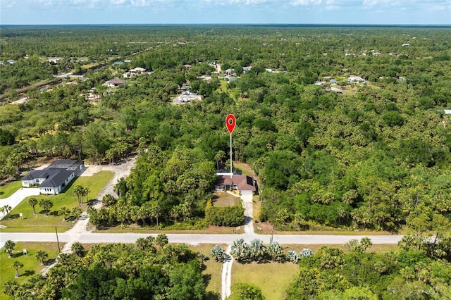2661 30th Ave SE, Naples, FL 34117 - birds eye view of property with a wooded view