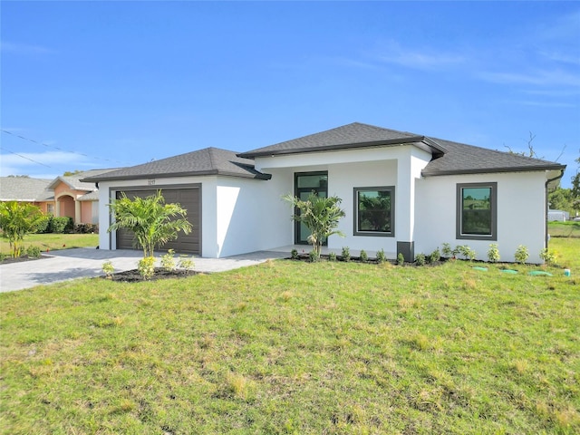 3217 23rd St SW, Lehigh Acres, FL 33976 - prairie-style home featuring a front yard, an attached garage, stucco siding, and concrete driveway