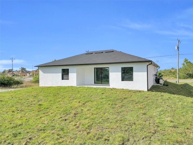 3217 23rd St SW, Lehigh Acres, FL 33976 - back of house featuring a lawn, a patio, and stucco siding