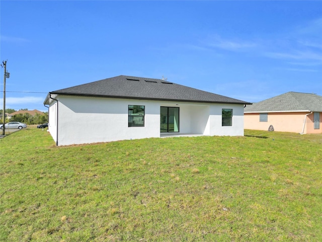 3217 23rd St SW, Lehigh Acres, FL 33976 - rear view of house with stucco siding and a lawn