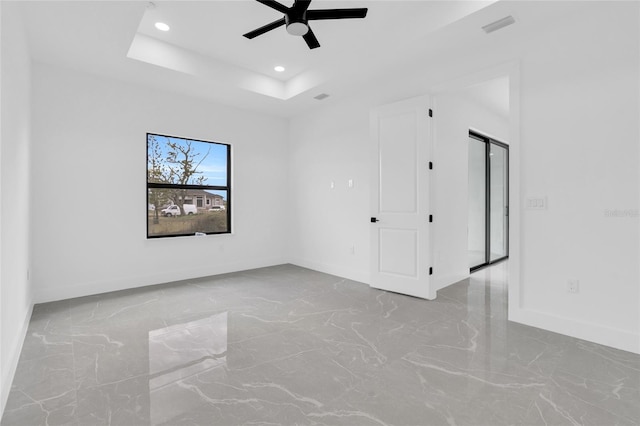 3217 23rd St SW, Lehigh Acres, FL 33976 - empty room with baseboards, a tray ceiling, recessed lighting, and a ceiling fan
