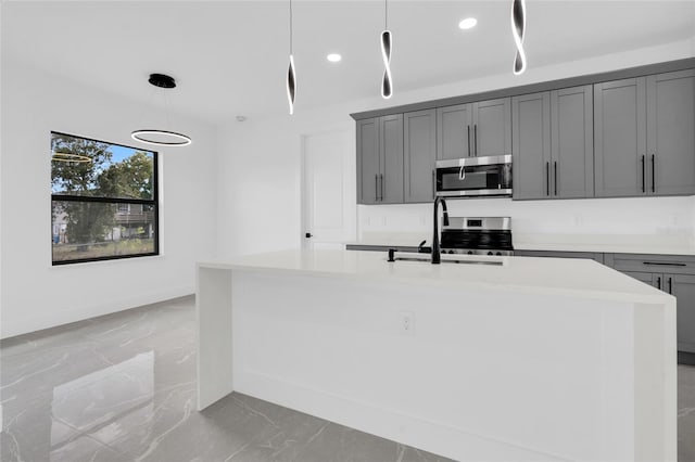 3217 23rd St SW, Lehigh Acres, FL 33976 - kitchen with marble finish floor, gray cabinetry, a sink, and stainless steel appliances