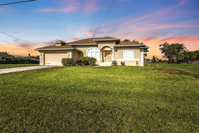 235 Tournament Rd, Rotonda West, FL 33947 - mediterranean / spanish home featuring a front lawn, stucco siding, a garage, and concrete driveway