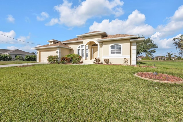 235 Tournament Rd, Rotonda West, FL 33947 - mediterranean / spanish house with a front lawn, an attached garage, driveway, and stucco siding