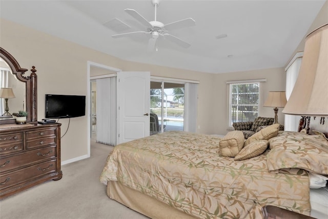 235 Tournament Rd, Rotonda West, FL 33947 - bedroom with access to exterior, a ceiling fan, and light carpet