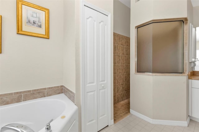 235 Tournament Rd, Rotonda West, FL 33947 - bathroom with a closet, walk in shower, tile patterned floors, and a garden tub