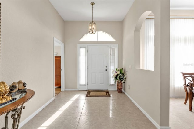 235 Tournament Rd, Rotonda West, FL 33947 - entrance foyer featuring arched walkways, baseboards, and plenty of natural light