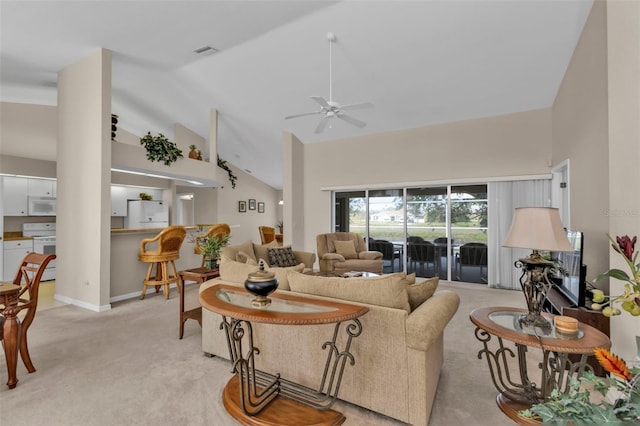 235 Tournament Rd, Rotonda West, FL 33947 - living room with visible vents, baseboards, a ceiling fan, high vaulted ceiling, and light colored carpet