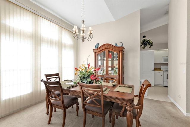 235 Tournament Rd, Rotonda West, FL 33947 - dining room featuring a chandelier, a healthy amount of sunlight, light colored carpet, and lofted ceiling