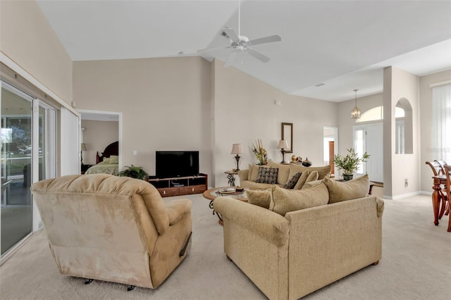 235 Tournament Rd, Rotonda West, FL 33947 - living area featuring baseboards, arched walkways, ceiling fan, high vaulted ceiling, and light carpet