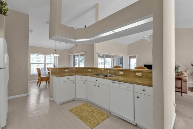 235 Tournament Rd, Rotonda West, FL 33947 - kitchen featuring ceiling fan with notable chandelier, white appliances, white cabinets, a sink, and hanging light fixtures