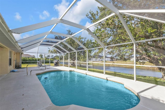 235 Tournament Rd, Rotonda West, FL 33947 - outdoor pool featuring a patio, glass enclosure, and a water view