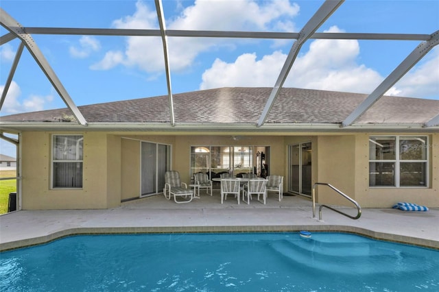 235 Tournament Rd, Rotonda West, FL 33947 - rear view of property with an outdoor pool, glass enclosure, a patio, and stucco siding