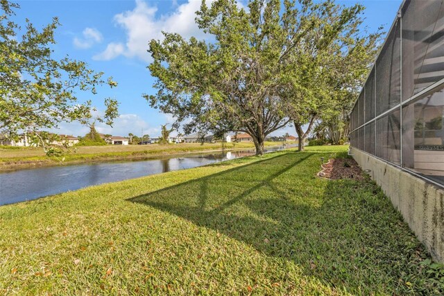235 Tournament Rd, Rotonda West, FL 33947 - view of yard with glass enclosure and a water view