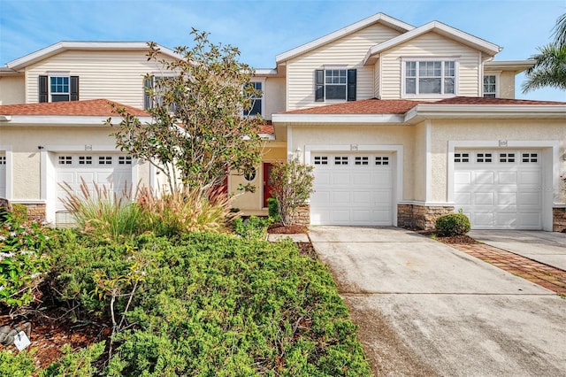 1156 Jonah Dr, North Port, FL 34289 - view of front of property featuring stone siding, an attached garage, stucco siding, and driveway