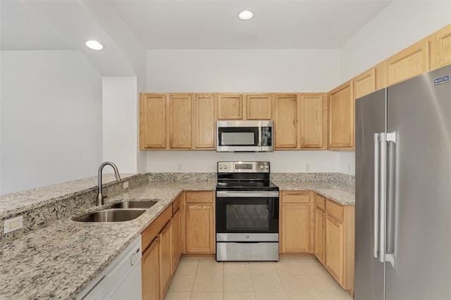 1156 Jonah Dr, North Port, FL 34289 - kitchen featuring light brown cabinets, a sink, light stone countertops, light tile patterned floors, and stainless steel appliances