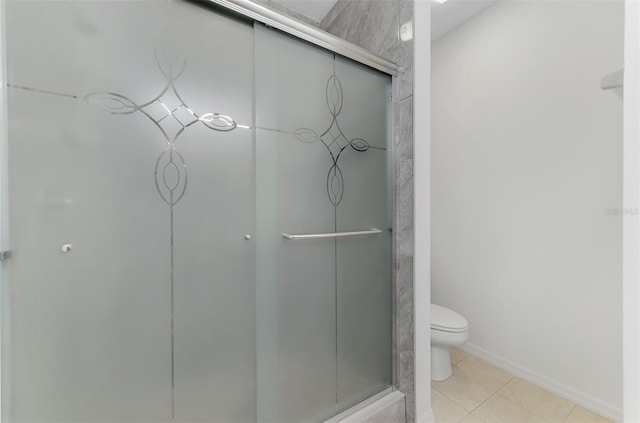1156 Jonah Dr, North Port, FL 34289 - bathroom featuring a stall shower, tile patterned floors, toilet, and baseboards