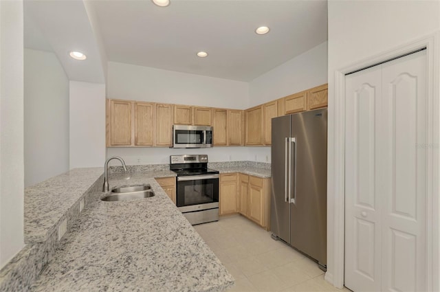 1156 Jonah Dr, North Port, FL 34289 - kitchen with a sink, light brown cabinetry, a peninsula, stainless steel appliances, and recessed lighting
