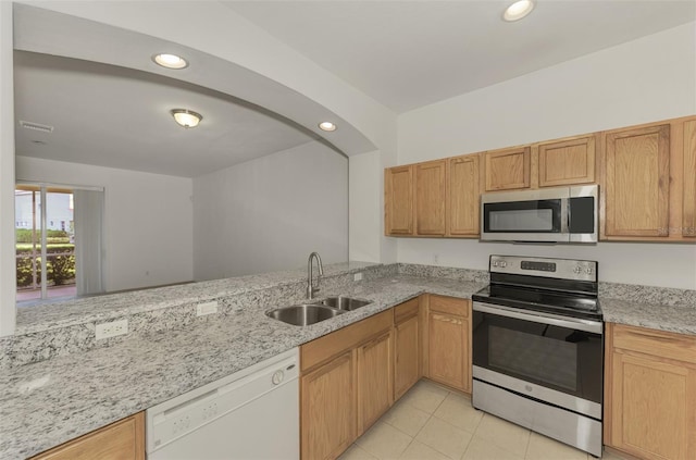 1156 Jonah Dr, North Port, FL 34289 - kitchen with stainless steel appliances, recessed lighting, a sink, light stone counters, and light tile patterned floors