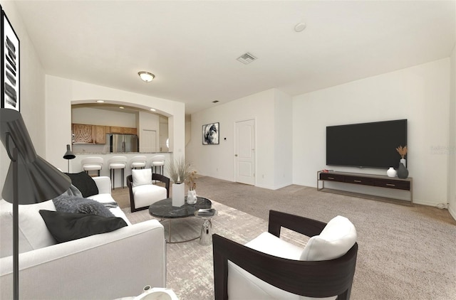 1156 Jonah Dr, North Port, FL 34289 - living room featuring light colored carpet, visible vents, arched walkways, and baseboards