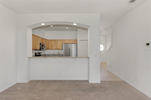 1156 Jonah Dr, North Port, FL 34289 - kitchen featuring stainless steel appliances, recessed lighting, light carpet, arched walkways, and a sink